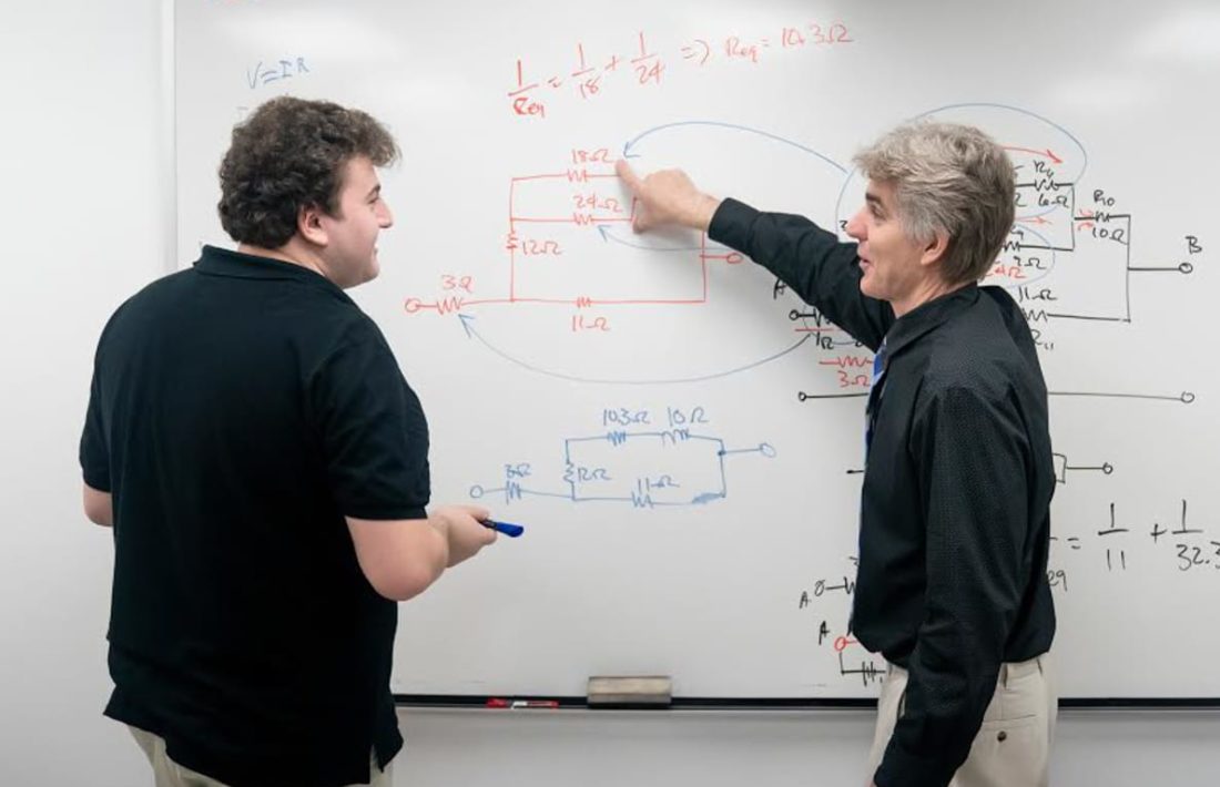 Staff and student working at a whiteboard during the Algebra Review program