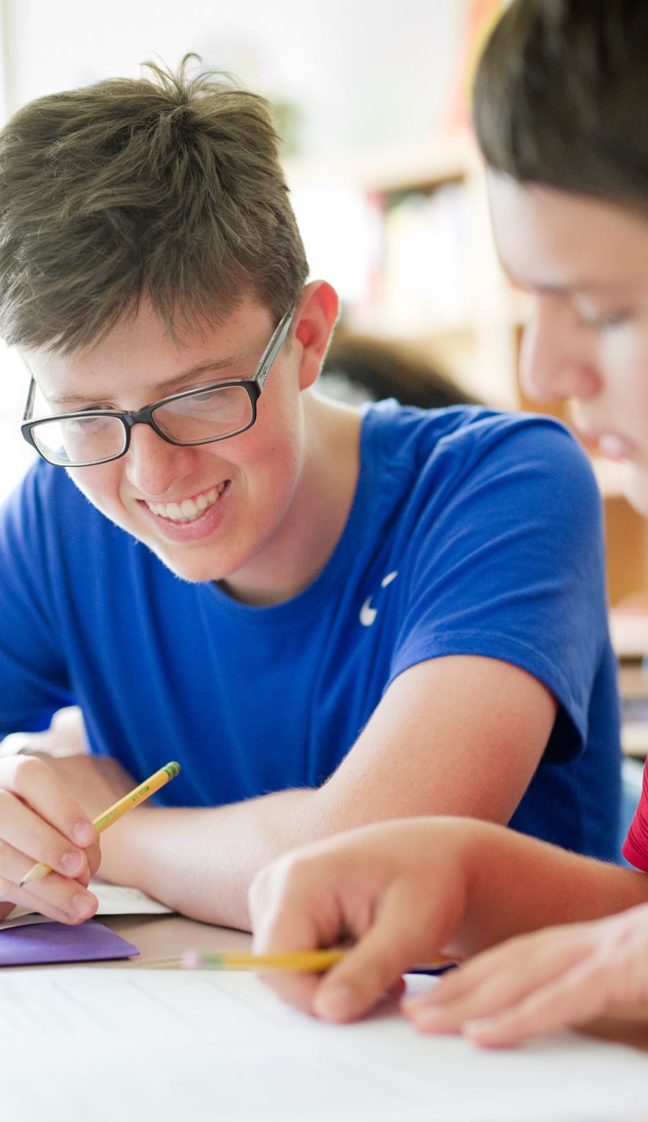 Two older boys collaborating at algebra