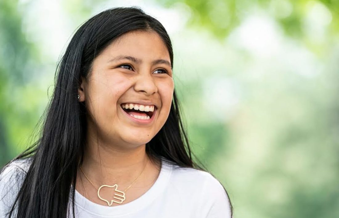 Female counselor in training laughing outside