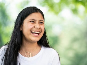 Female counselor in training laughing outside