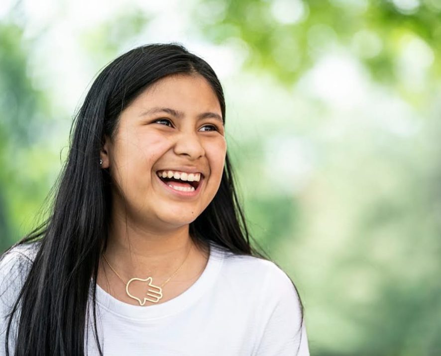 Female counselor in training laughing outside