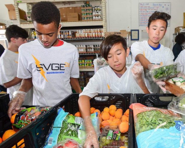 Kids volunteering at a food bank for community service program