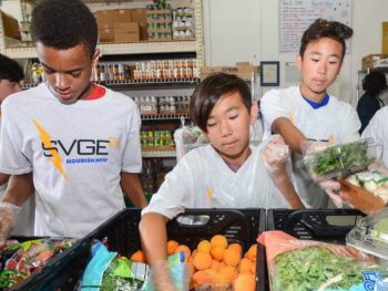 Kids volunteering at a food bank for community service program