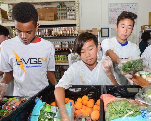 Kids volunteering at a food bank for community service program