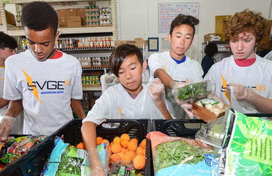 Kids volunteering at a food bank for community service program