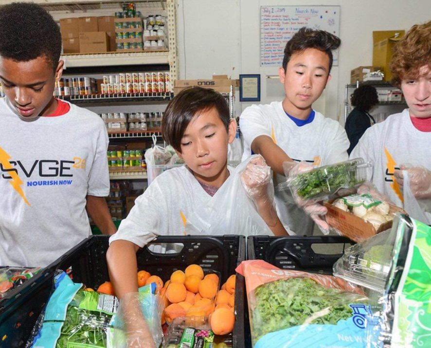 Kids volunteering at a food bank for community service program