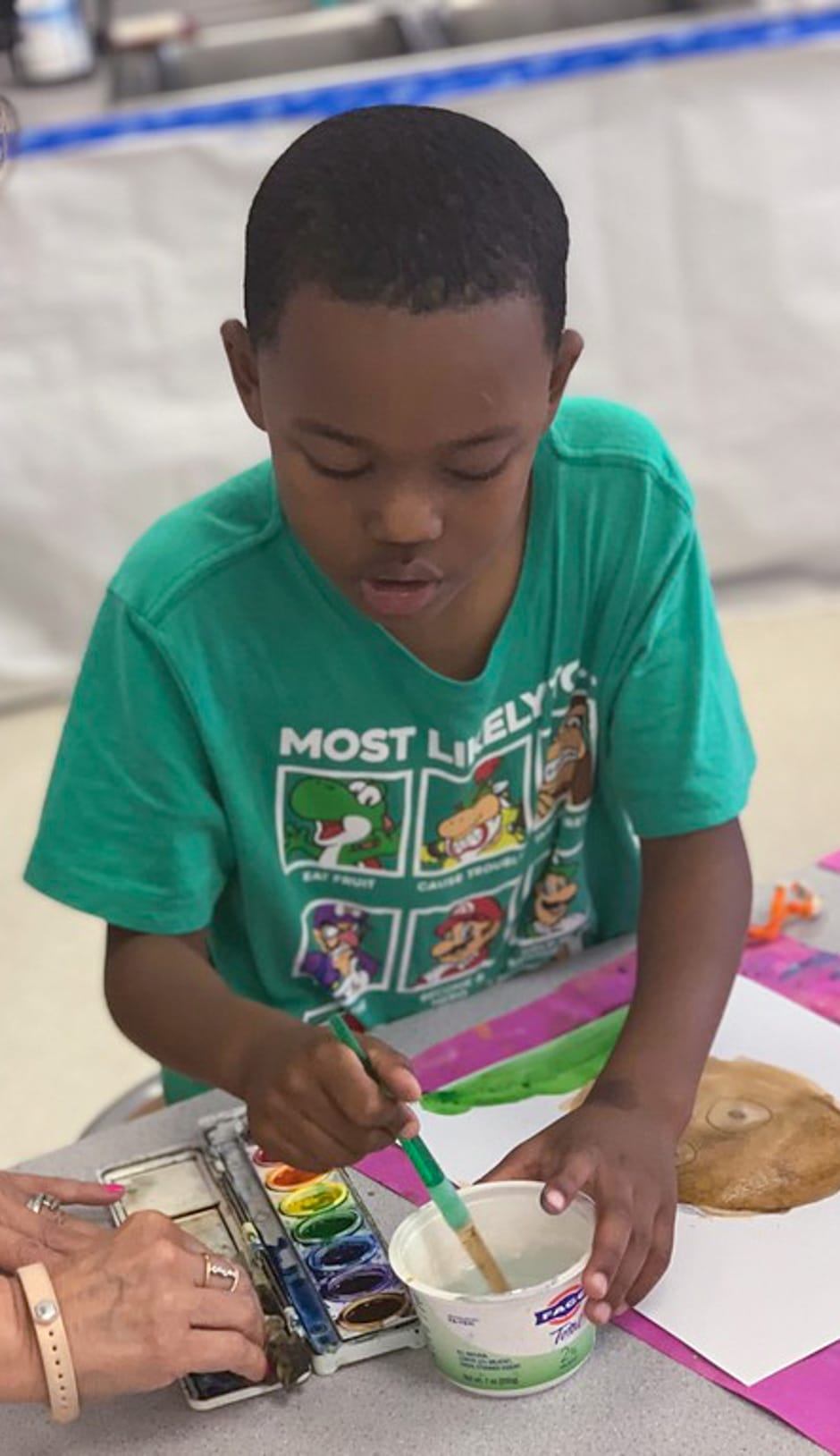 Boy painting during the Edge Afternoon program