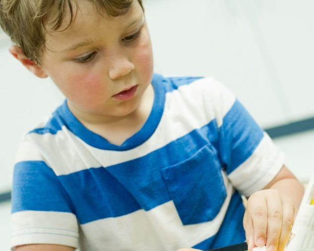 Young boy making an art project