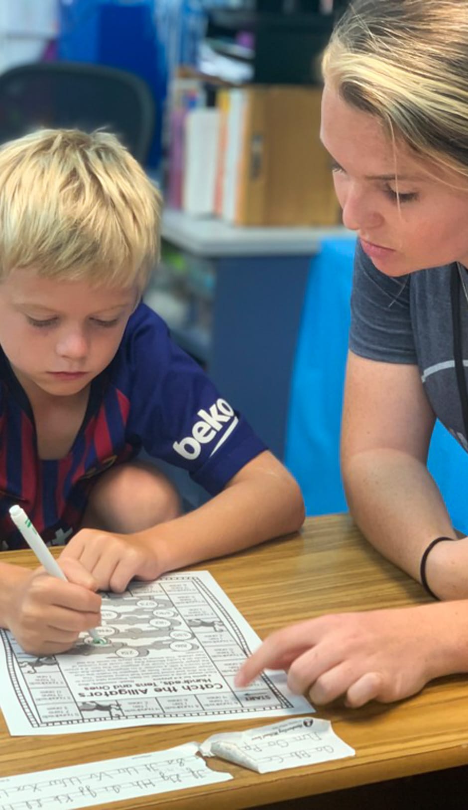 Staff helping male student at the Learning Leaps program