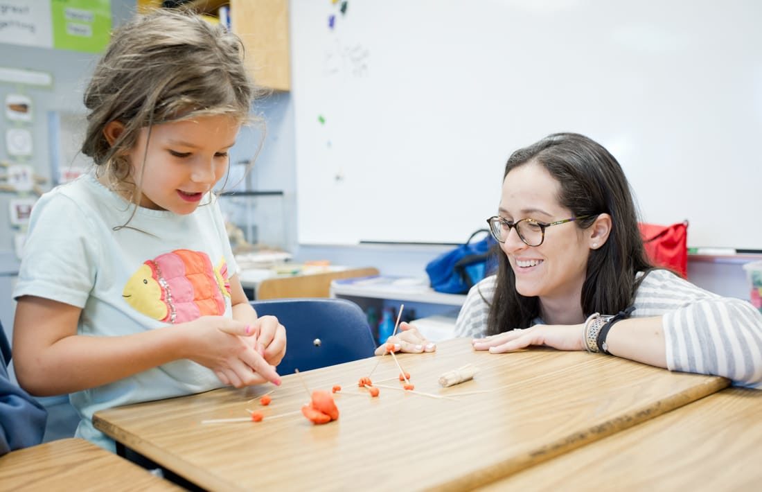 Staff and student using clay to think about math problems