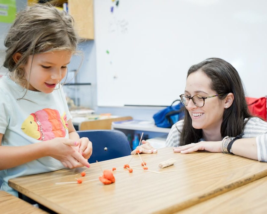 Staff and student using clay to think about math problems