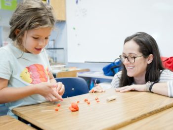 Staff and student using clay to think about math problems