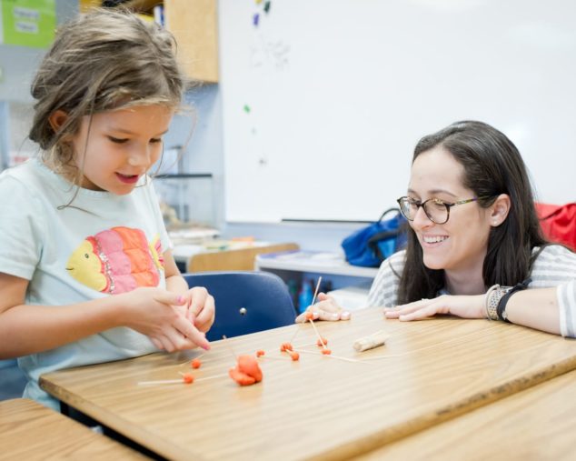 Staff and student using clay to think about math problems