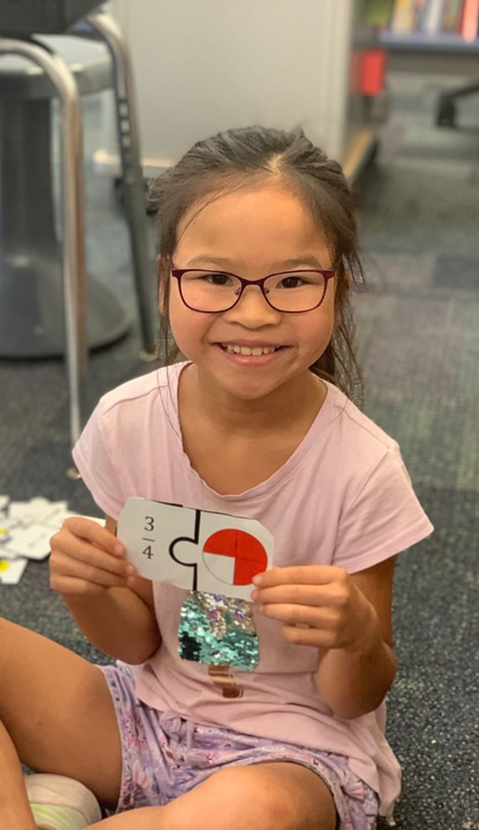 Young female holding ratio cards for algebra program