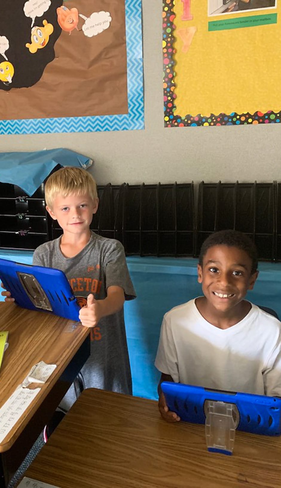 Two boys learning writing techniques on the computer