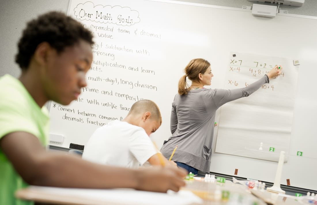 Student taking notes in Middle School Math program