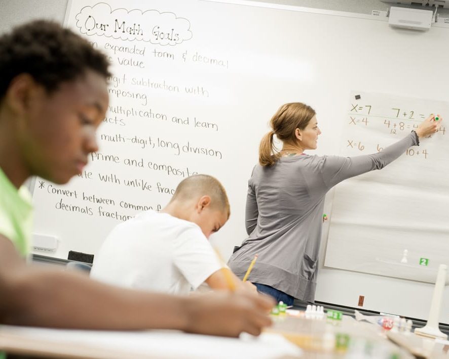 Student taking notes in Middle School Math program