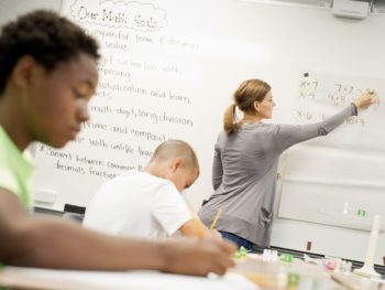 Student taking notes in Middle School Math program