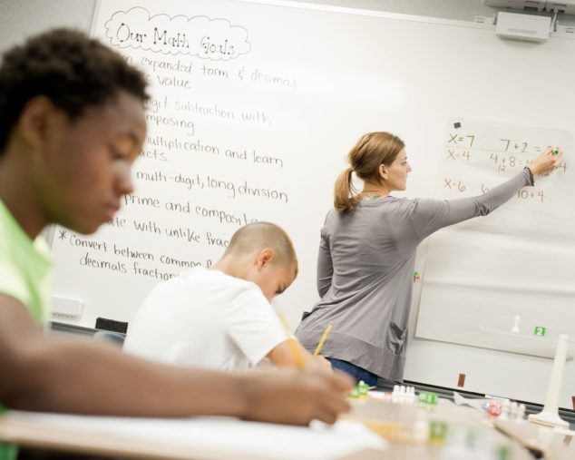 Student taking notes in Middle School Math program