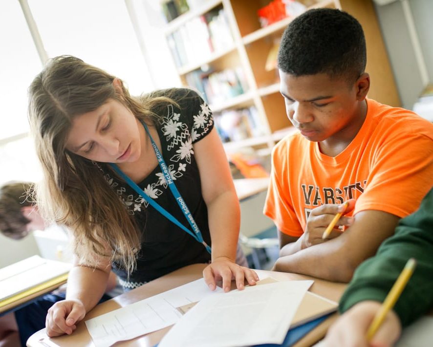 Staff helping a student at reading