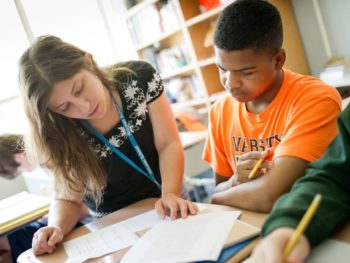 Staff helping a student at reading