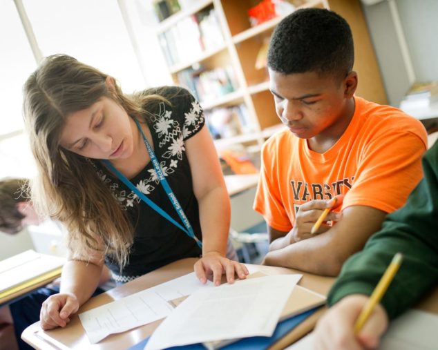 Staff helping a student at reading