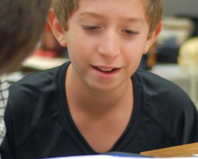 Middle school student practicing his writing