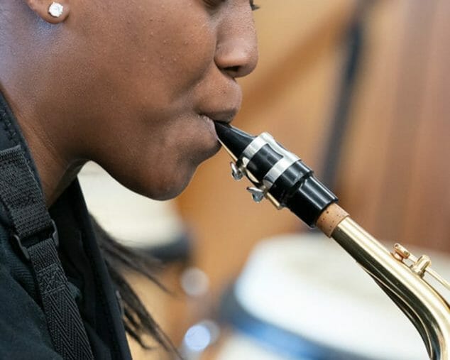 Teen girl playing an instrument in Rock Band