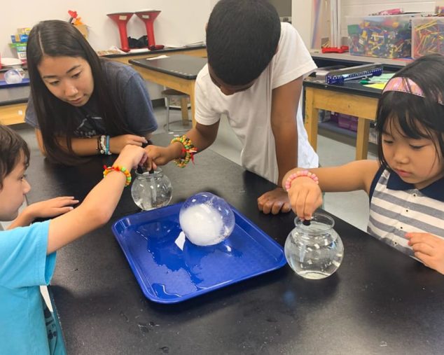 Students dropping solvent into a bowl of water