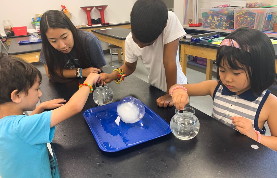 Students dropping solvent into a bowl of water