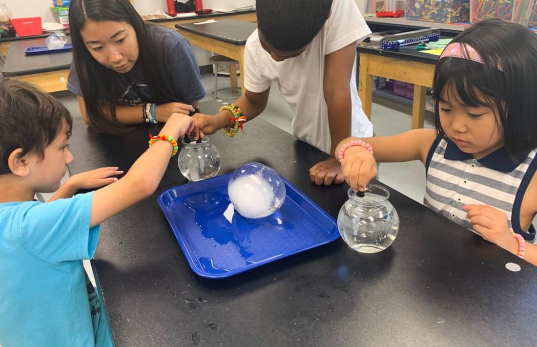 Students dropping solvent into a bowl of water