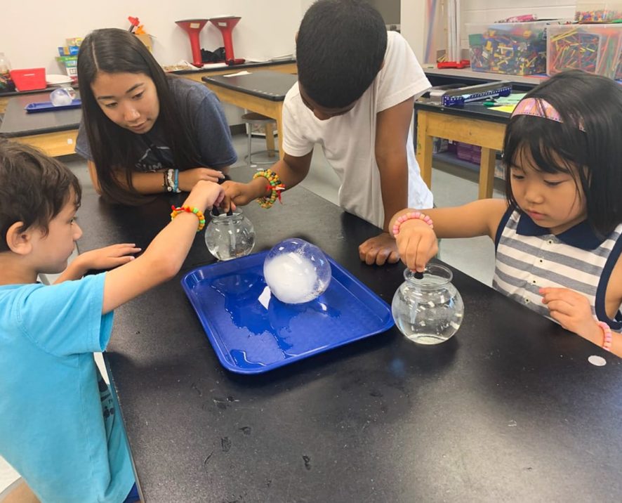 Students dropping solvent into a bowl of water