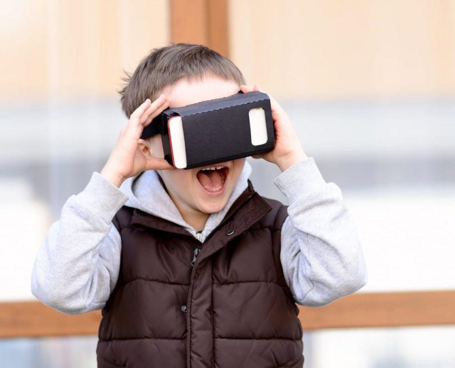 Boy using a virtual reality device