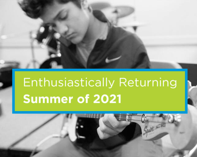 Older student playing guitar in the Rock Band program