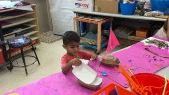 A student making a sailboat.