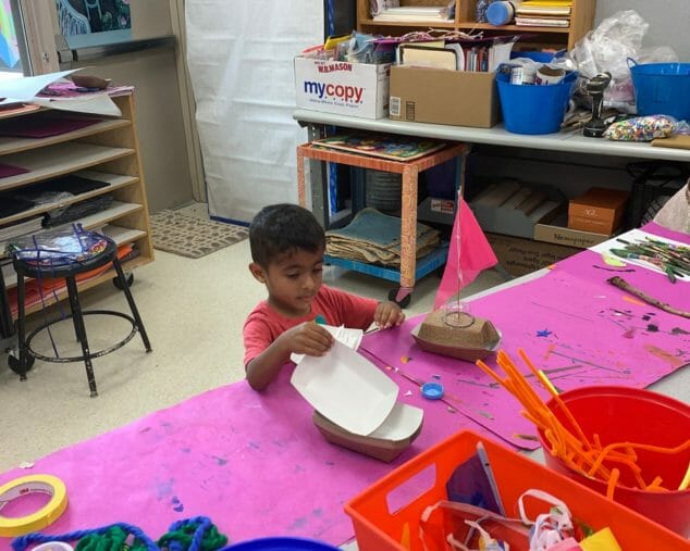 A student making a sailboat.